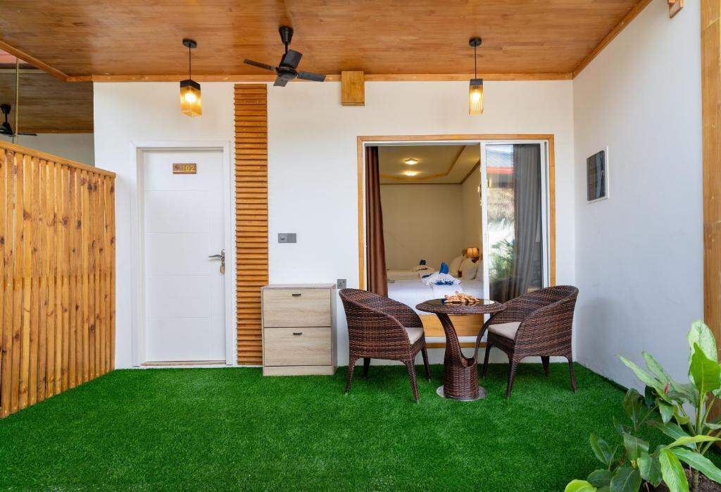 Tropico Villa terrace with garden seating in Ukulhas, Maldives
