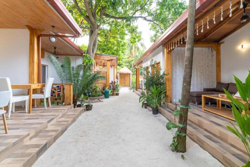 Sandy garden pathway between the villa buildings at Tropico Villa in Ukulhas